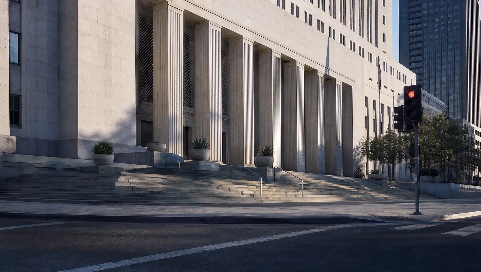 The stone steps and columned facade of a civic courthouse building in downtown Los Angeles