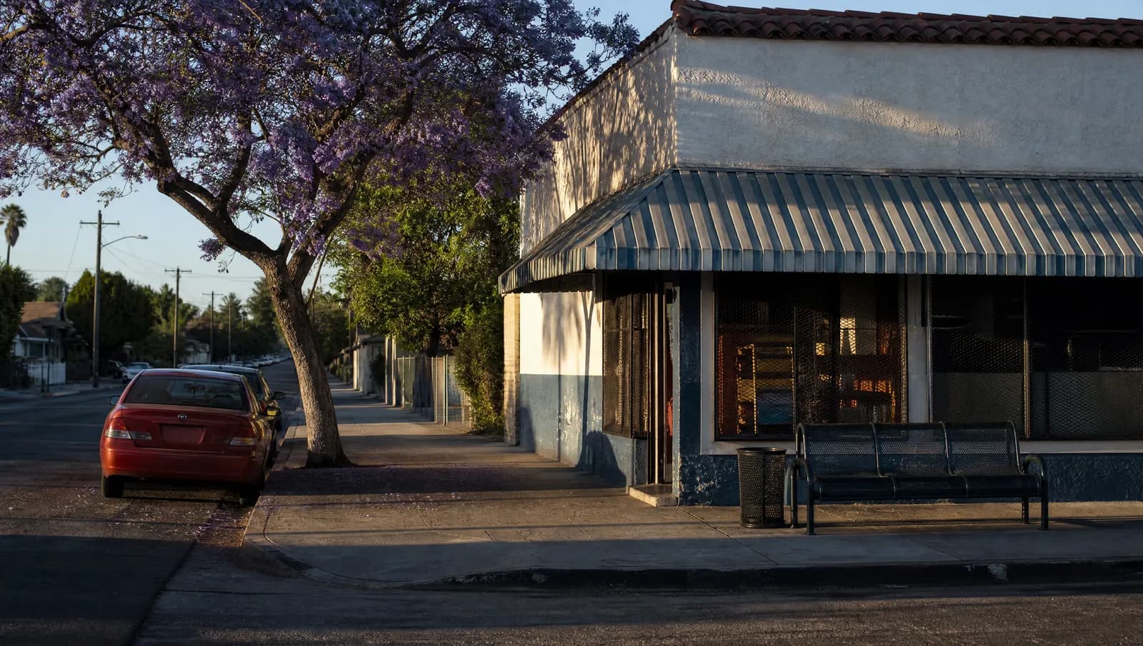 A quiet Los Angeles neighborhood commercial street in late afternoon light